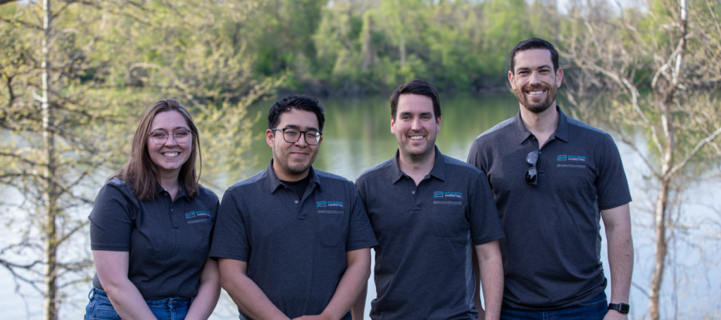 photo of the Bold River team smiling in front of a lake