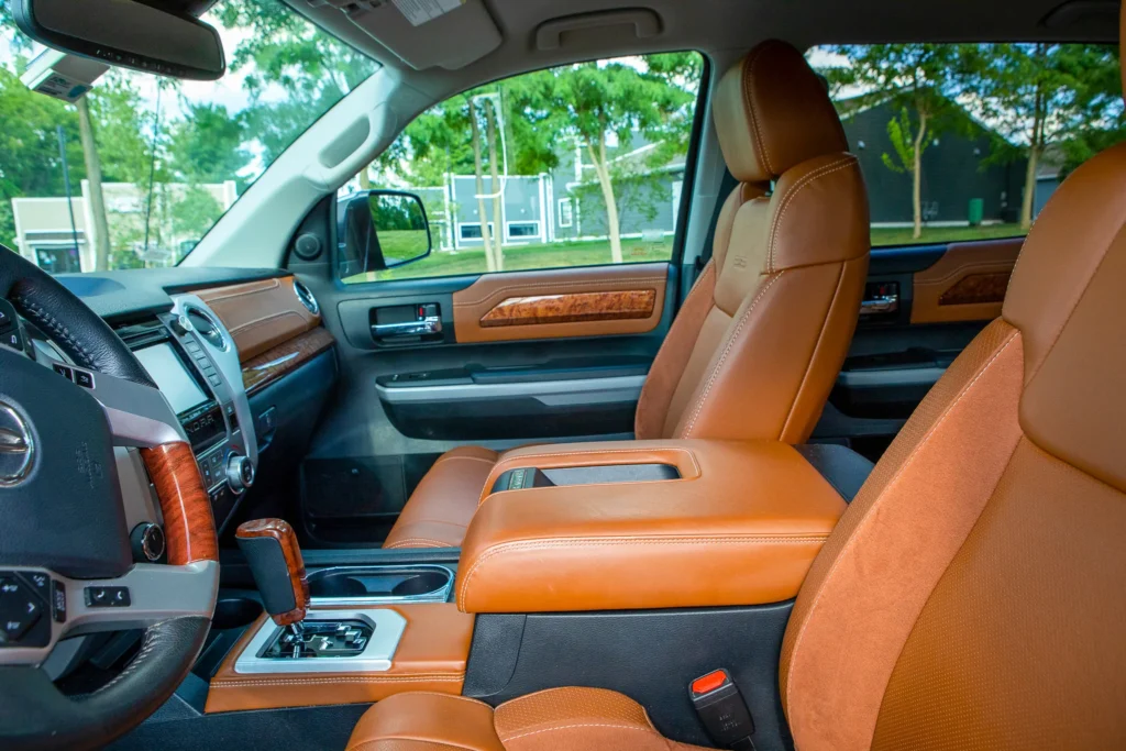A photo of a brown truck's front interior