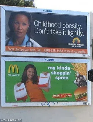 An advertisement warning against childhood obesity posted over an advertisement for McDonalds