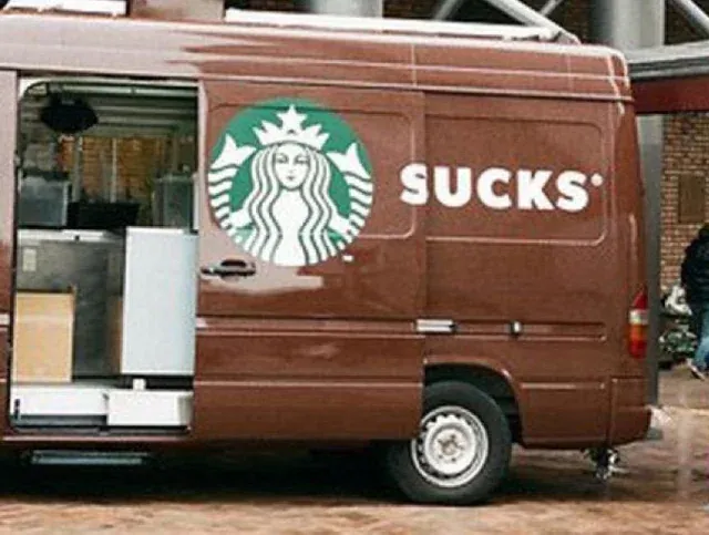 A Starbucks van that's been left open, covering part of the logo and making it look like it says "Sucks" with the mermaid logo in front of the word.